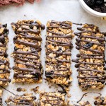 These no bake Dried Cherry, Almond + Chocolate Chip Granola Bars are the perfect grab and go breakfast or snack. These flavor-packed granola bars are gluten free, refined sugar free, vegan, and topped with a dark chocolate drizzle!