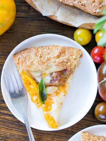 This Mozzarella Heirloom Tomato Galette showcases beautiful heirloom tomatoes bubbling with melted mozzarella cheese, all tucked into a gluten-free + grain-free Parmesan crust.