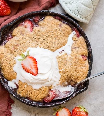 This Strawberry Cobbler recipe makes a small batch that's perfect for sharing between a few people. This gluten-free, Paleo, and vegan dessert is made even better with some whipped coconut cream!