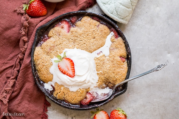 This Strawberry Cobbler recipe makes a small batch that's perfect for sharing between a few people. This gluten-free, Paleo, and vegan dessert is made even better with some whipped coconut cream!