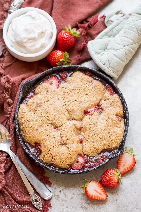 This Strawberry Cobbler recipe makes a small batch that's perfect for sharing between a few people. This gluten-free, Paleo, and vegan dessert is made even better with some whipped coconut cream!