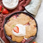 This Strawberry Cobbler recipe makes a small batch that's perfect for sharing between a few people. This gluten-free, Paleo, and vegan dessert is made even better with some whipped coconut cream!