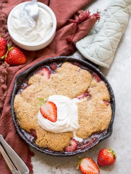This Strawberry Cobbler recipe makes a small batch that's perfect for sharing between a few people. This gluten-free, Paleo, and vegan dessert is made even better with some whipped coconut cream!