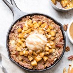 This Apple Cinnamon Skillet Cookie is a deep-dish spiced cookie that's loaded with fresh diced apples and warm fall spices! This gluten-free, refined sugar-free, and Paleo-friendly skillet cookie is topped with caramelized apples.