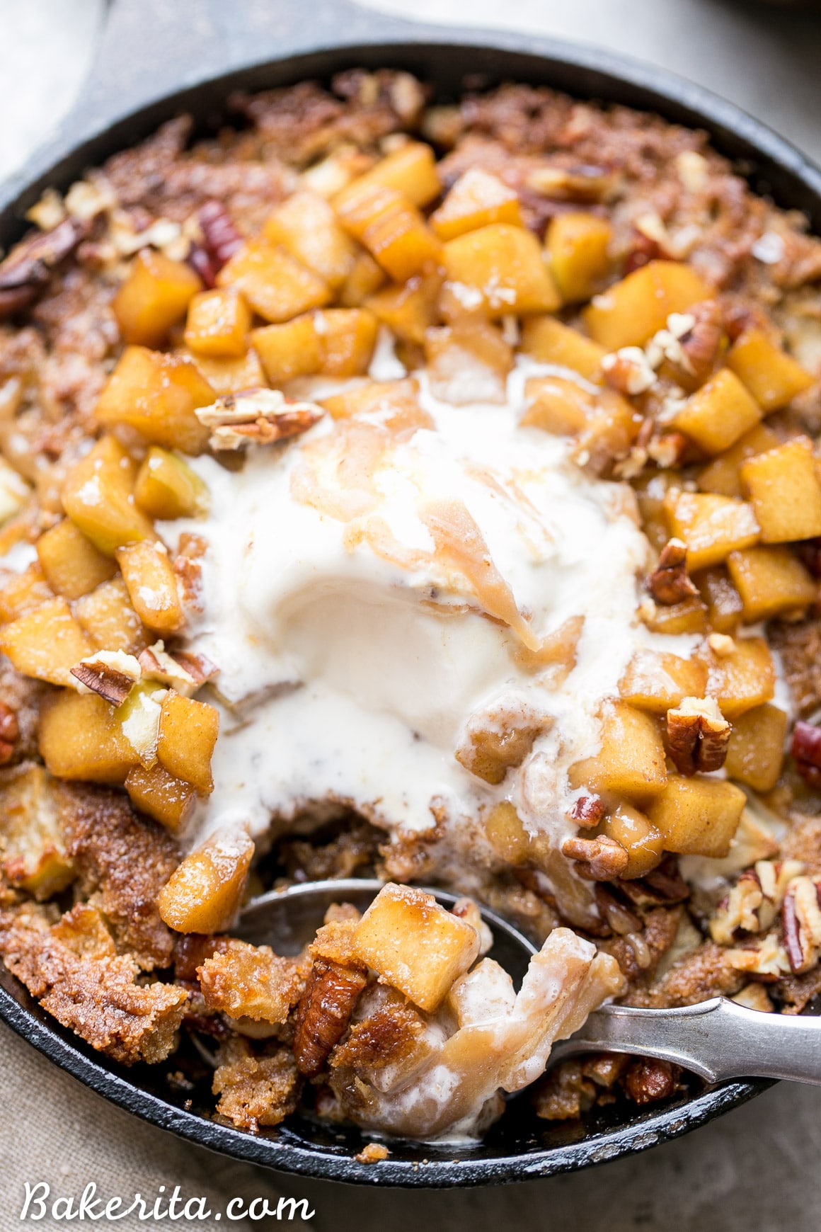 This Apple Cinnamon Skillet Cookie is a deep-dish spiced cookie that's loaded with fresh diced apples and warm fall spices! This gluten-free, refined sugar-free, and Paleo-friendly skillet cookie is topped with caramelized apples.