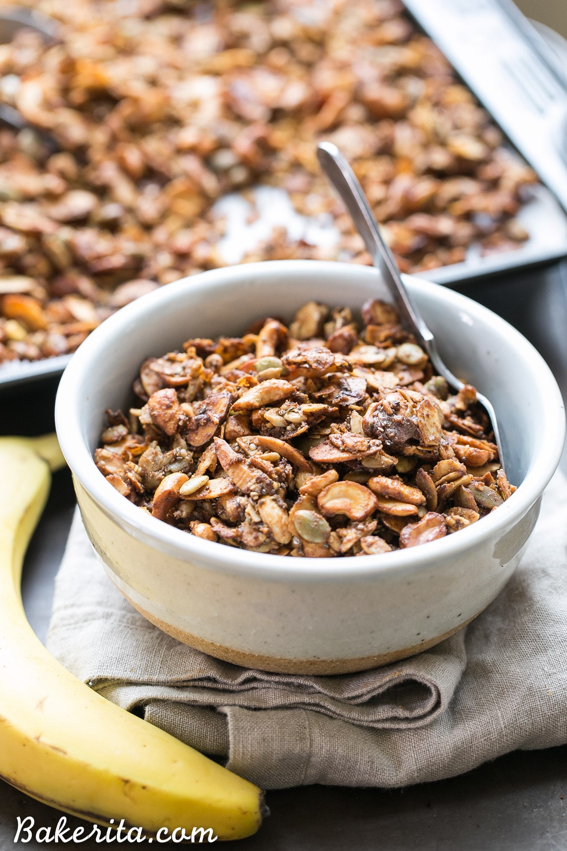 This Banana Almond Butter Grain Free Granola is a crunchy + filling snack, made without any grains or refined sugars! It makes the perfect yogurt or smoothie bowl topping, or just grab a handful to hold you over until your next meal.