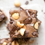 These Chocolate Hazelnut Bars have a hazelnut flour crust and are topped with dark chocolate chunks + crunchy hazelnuts. These gluten-free, Paleo + refined sugar free bars get even fudgier the day after they're made!