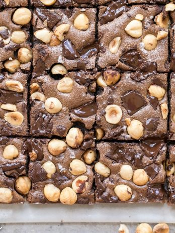 These Chocolate Hazelnut Bars have a hazelnut flour crust and are topped with dark chocolate chunks + crunchy hazelnuts. These gluten-free, Paleo + refined sugar free bars get even fudgier the day after they're made!