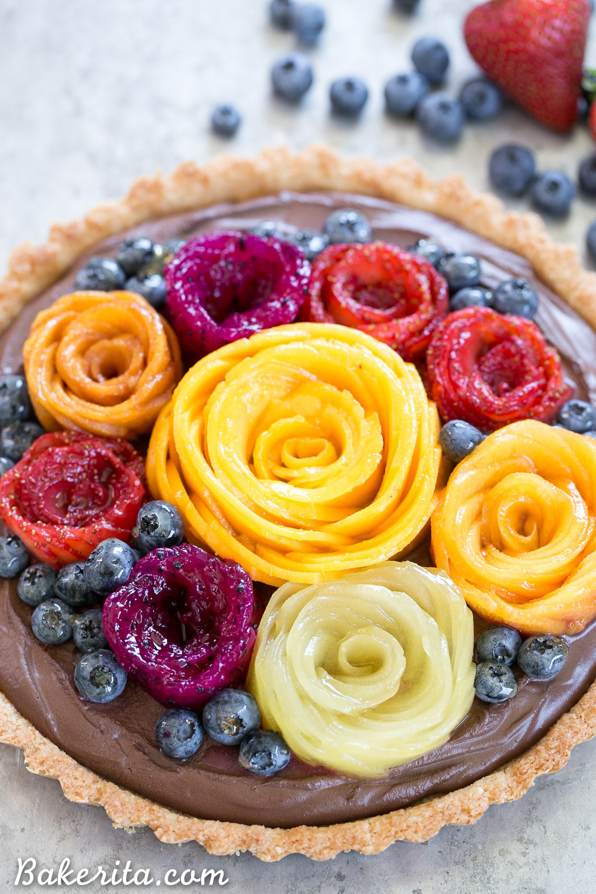 This Chocolate Mousse Tart with Coconut Crust + Fresh Fruit Flowers has the most incredible vegan chocolate mousse filling! You'd never guess that this rich dessert is gluten-free, Paleo, and vegan.