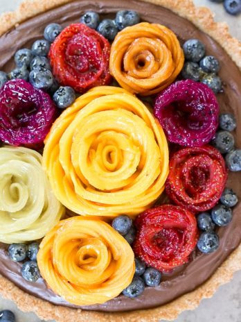 This Chocolate Mousse Tart with Coconut Crust + Fresh Fruit Flowers has the most incredible vegan chocolate mousse filling! You'd never guess that this rich dessert is gluten-free, Paleo, and vegan.