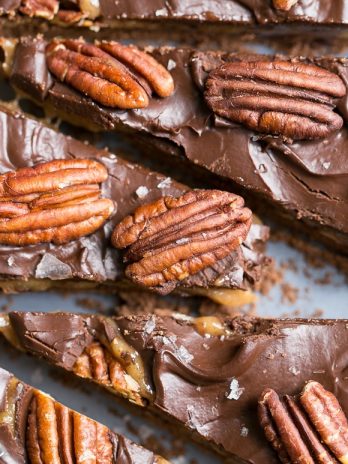 This Chocolate Pecan Tart has a chocolate shortbread crust, pecan pie filling, and is topped with dark chocolate ganache, pecans + a sprinkle of sea salt! You won't believe that this is gluten-free, Paleo, refined sugar free, and vegan.