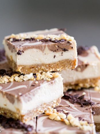 These No-Bake Chocolate Peanut Butter Cheesecake Bars have a peanut date crust and a super creamy cashew-based peanut butter filling - you'd never guess that they're vegan, gluten free, and refined sugar free!