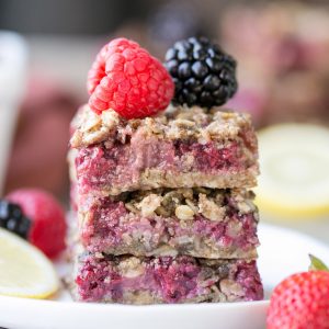 These Lemon Berry Oatmeal Snack Bars are the perfect mid-day treat or dessert to satisfy your hunger! These snack bars have an oatmeal crust, a tangy lemon mixed berry filling, and they're gluten-free + vegan.