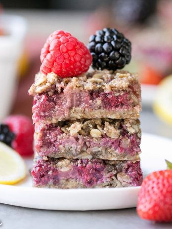 These Lemon Berry Oatmeal Snack Bars are the perfect mid-day treat or dessert to satisfy your hunger! These snack bars have an oatmeal crust, a tangy lemon mixed berry filling, and they're gluten-free + vegan.