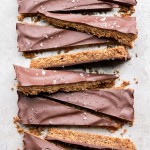 These Brown Butter Shortbread are crisp and buttery with dark chocolate + flaky sea salt on top. These gluten free & refined sugar free cookies melt in your mouth and make the perfect addition to your holiday cookie tray!