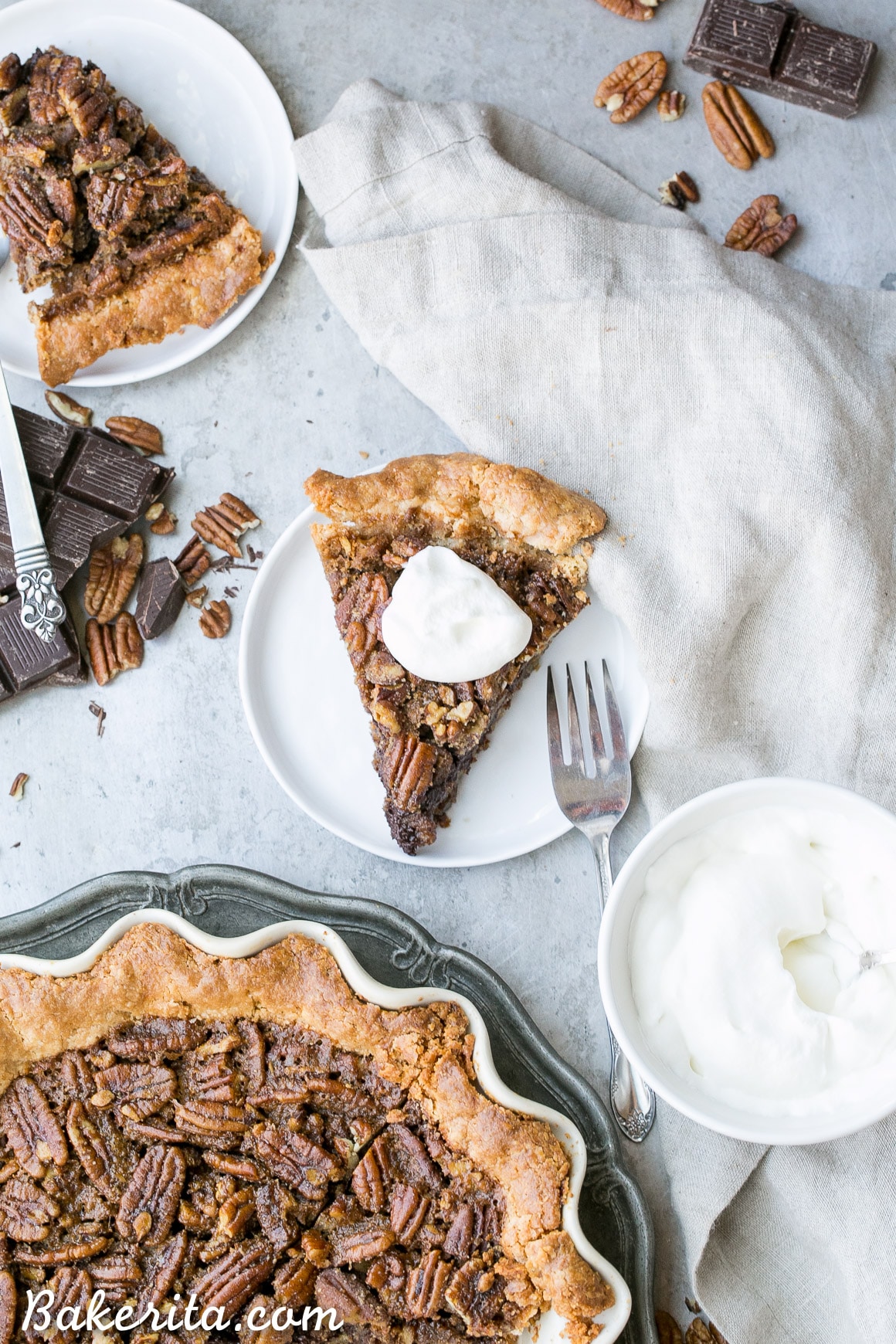 This Paleo Chocolate Pecan Pie has a flaky grain-free pie crust and a layer of chocolate ganache! This gluten-free and refined sugar-free pie is gooey, crunchy, and the perfect addition to your holiday dessert line-up.
