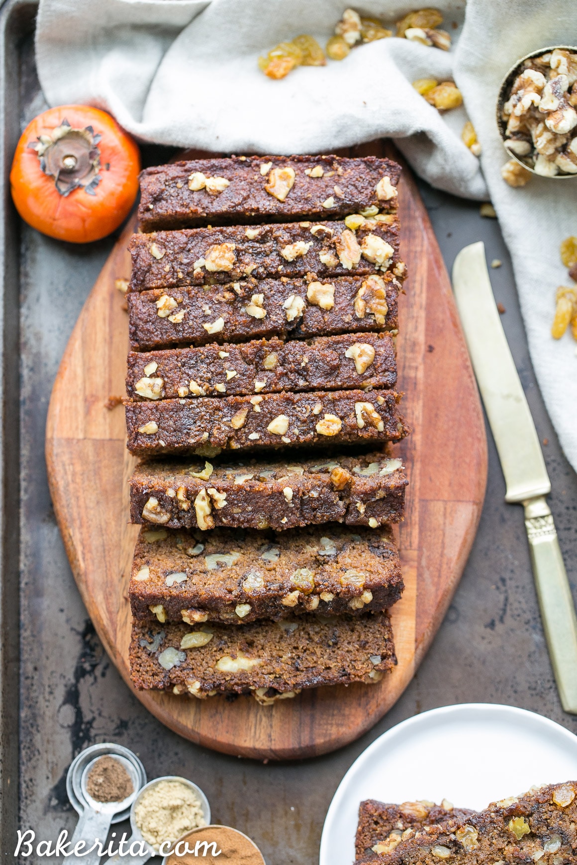 This Paleo Persimmon Bread is a healthy treat that uses pureed Fuyu persimmons for flavor and moisture, and is loaded with toasted walnuts & golden raisins! This gluten-free persimmon bread is spiced with cinnamon, ginger and allspice and makes a perfect breakfast or snack.