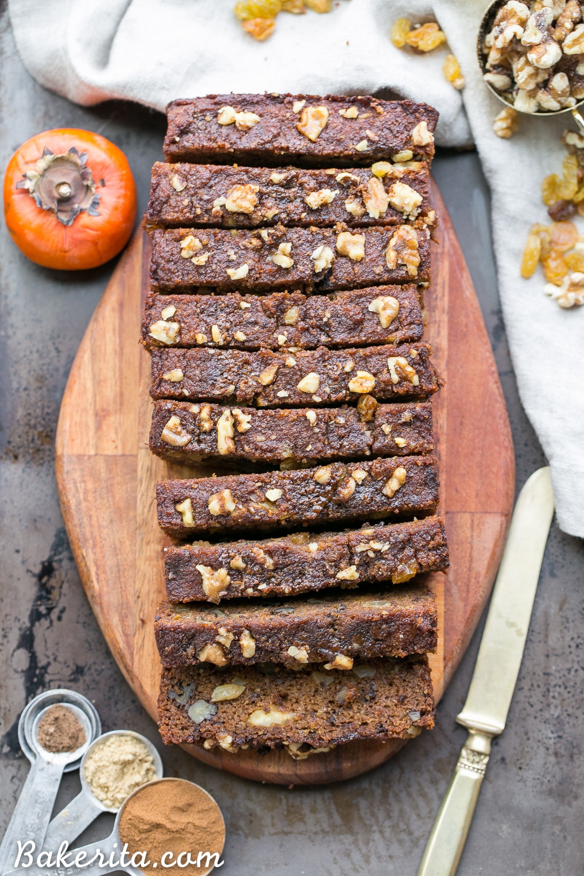 This Paleo Persimmon Bread is a healthy treat that uses pureed Fuyu persimmons for flavor and moisture, and is loaded with toasted walnuts & golden raisins! This gluten-free persimmon bread is spiced with cinnamon, ginger and allspice and makes a perfect breakfast or snack.