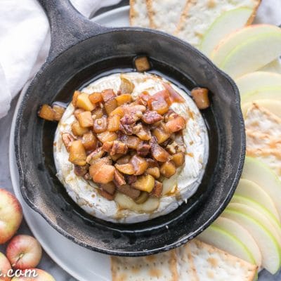Caramel Apple Baked Brie is a gooey, scrumptious appetizer that's perfect for holiday entertaining! This easy recipe has a caramel apple topping piled on top of wheel of melted brie. It only has 5 ingredients and takes 20 minutes from start to finish.