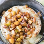 Caramel Apple Baked Brie is a gooey, scrumptious appetizer that's perfect for holiday entertaining! This easy recipe has a caramel apple topping piled on top of wheel of melted brie. It only has 5 ingredients and takes 20 minutes from start to finish.
