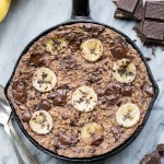 This easy Chocolate Chunk Banana Baked Oatmeal is a delicious twist on classic oatmeal - you'll definitely want to start your day with a serving of this gluten-free + vegan breakfast! This healthier oatmeal has no added sweetener; it's sweetened entirely with ripe banana and chocolate chunks.