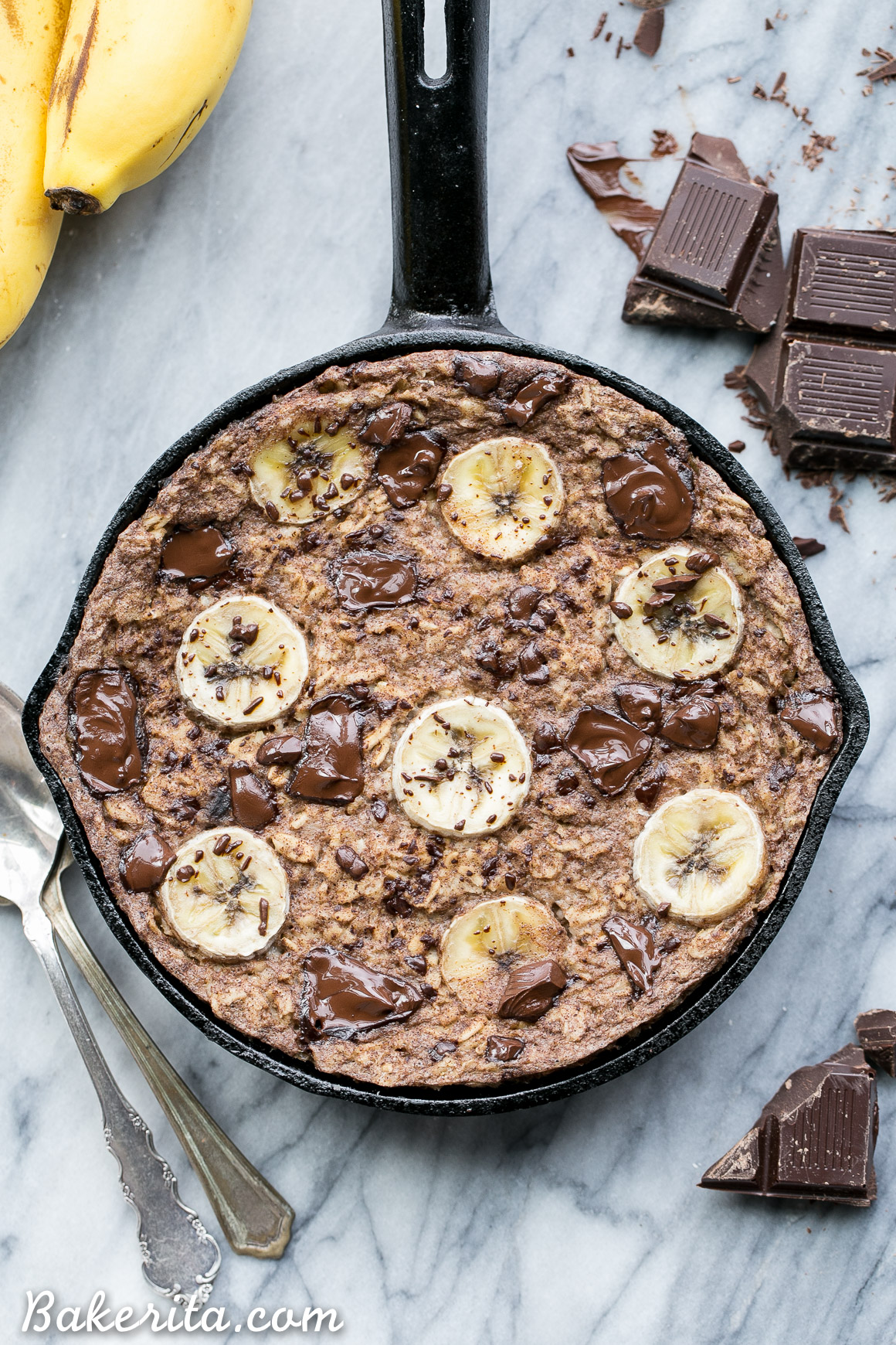 This easy Chocolate Chunk Banana Baked Oatmeal is a delicious twist on classic oatmeal - you'll definitely want to start your day with a serving of this gluten-free + vegan breakfast! This healthier oatmeal has no added sweetener; it's sweetened entirely with ripe banana and chocolate chunks.