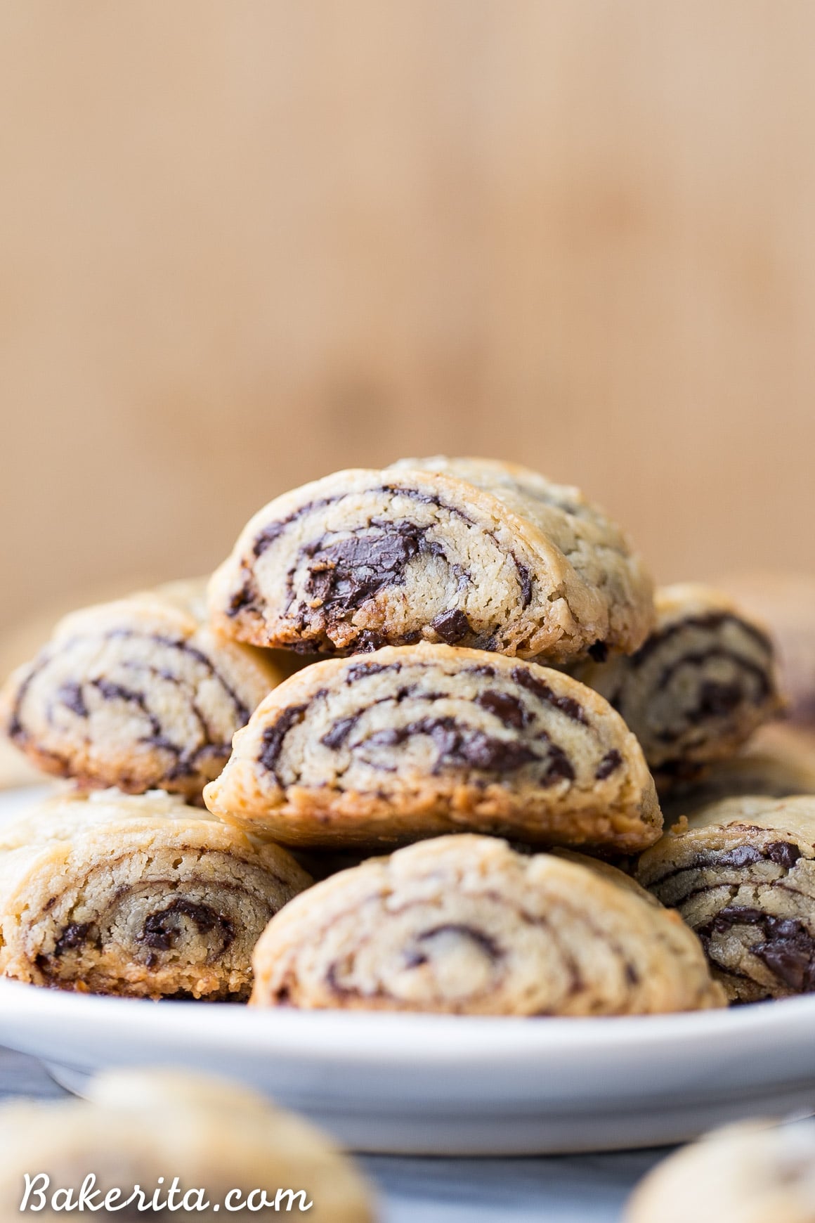 These Chocolate Rugelach are incredibly tender and flaky, thanks to the cream cheese-based dough. These refined sugar-free and gluten-free rugelach are filled with dark chocolate shavings for an irresistible holiday treat. #bakerita #holidaytreat #glutenfree #refinedsugarfree #cookies #dessert 