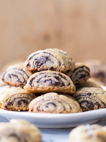 These Chocolate Rugelach are incredibly tender and flaky, thanks to the cream cheese-based dough. These refined sugar-free and gluten-free rugelach are filled with dark chocolate shavings for an irresistible holiday treat.