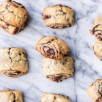 These Chocolate Rugelach are incredibly tender and flaky, thanks to the cream cheese-based dough. These refined sugar-free and gluten-free rugelach are filled with dark chocolate shavings for an irresistible holiday treat.