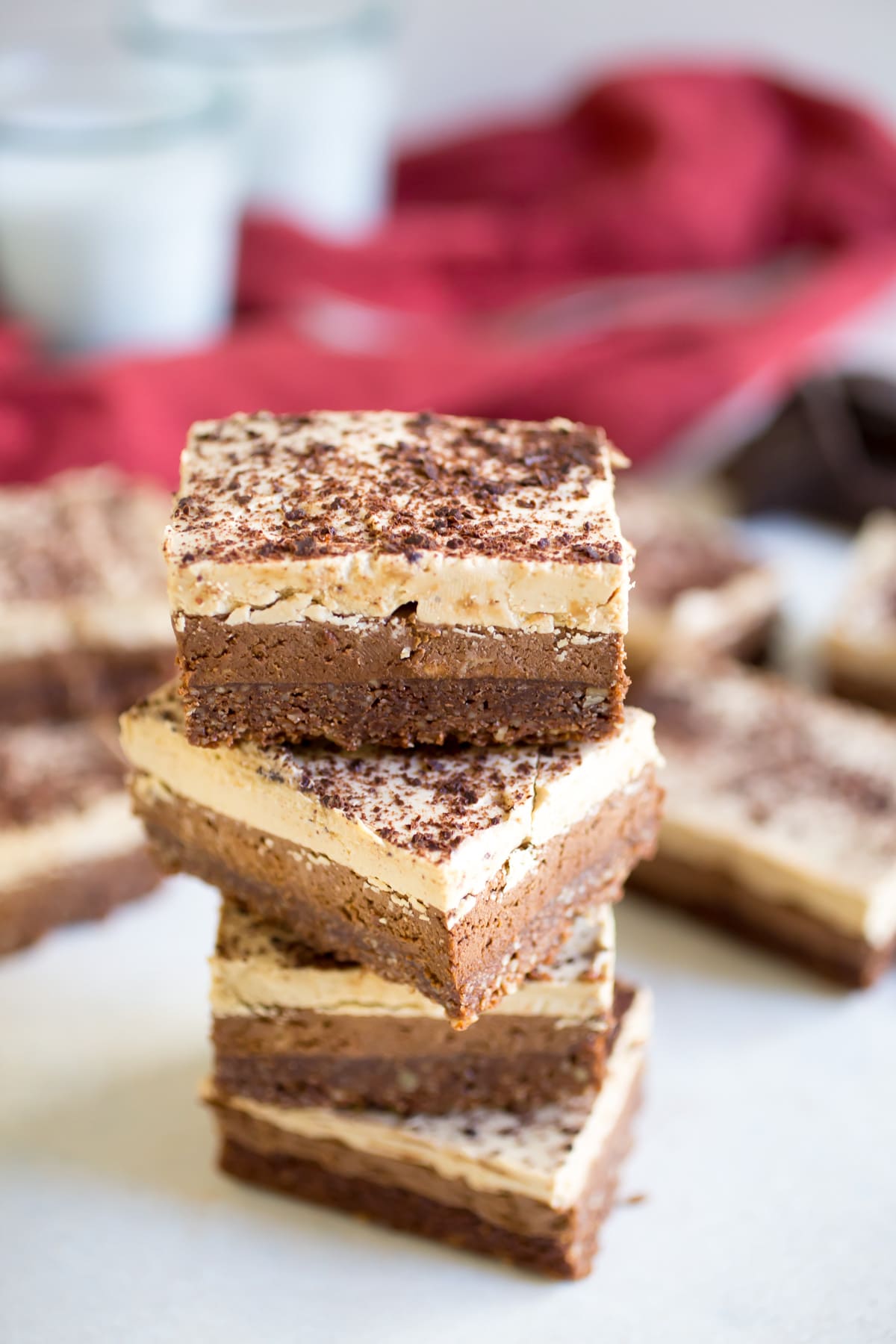 These Paleo Triple Chocolate Layer Bars have a chocolate pecan crust with a chocolate mousse layer and a buttercream topping! You're going to love this irresistible dessert.