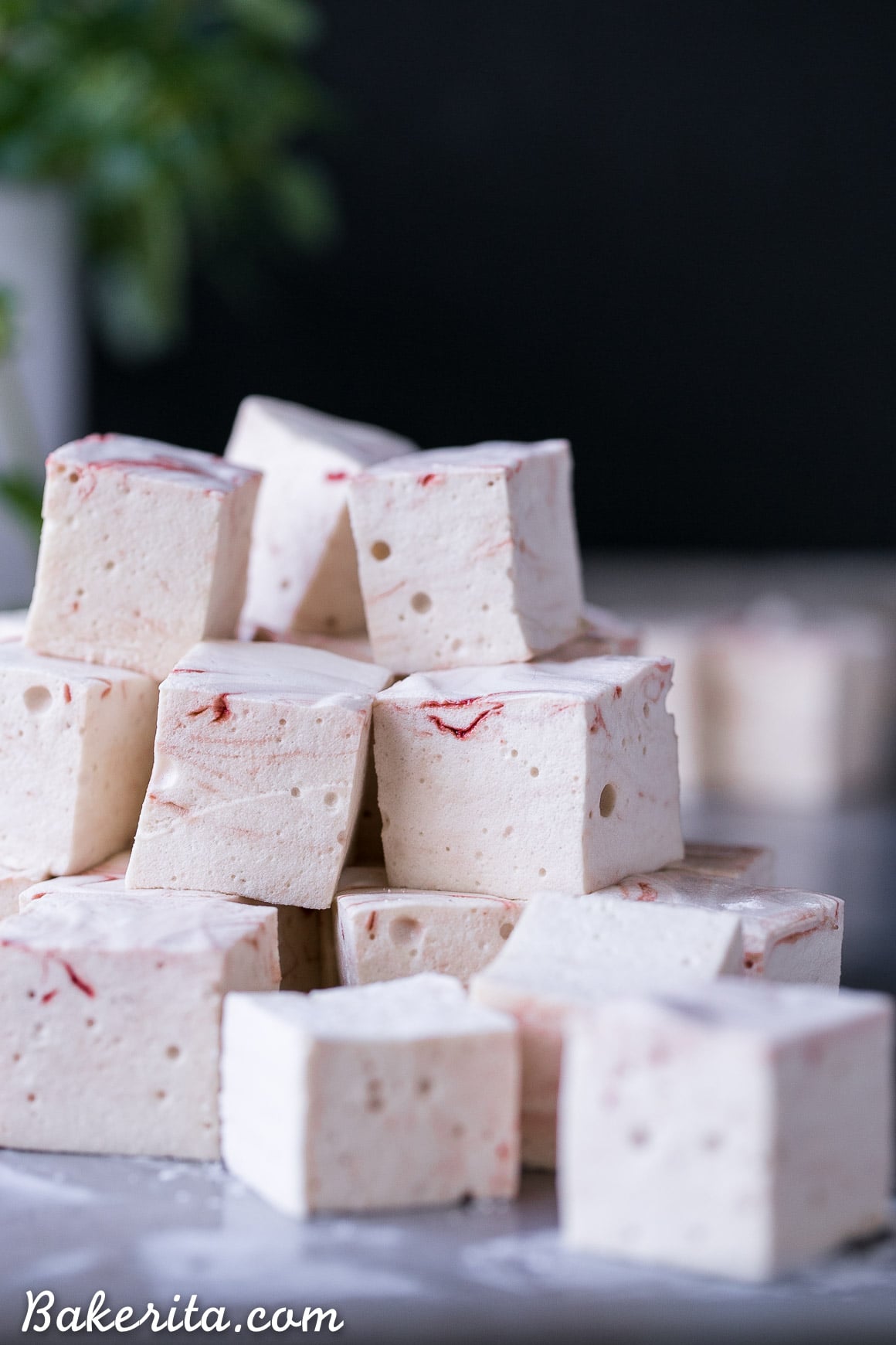 These Paleo Peppermint Marshmallows are exactly what your hot chocolate needs! They're light, fluffy, and easier to make than you'd think. This recipe is Paleo + refined sugar free, with a beautiful swirl of homemade red food coloring!