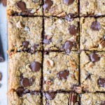 These Pumpkin Oatmeal Scotchie Bars with Chocolate Chips + Pecans are soft, gooey, and absolutely irresistible! These decadent dessert bars couldn't be easier to make.