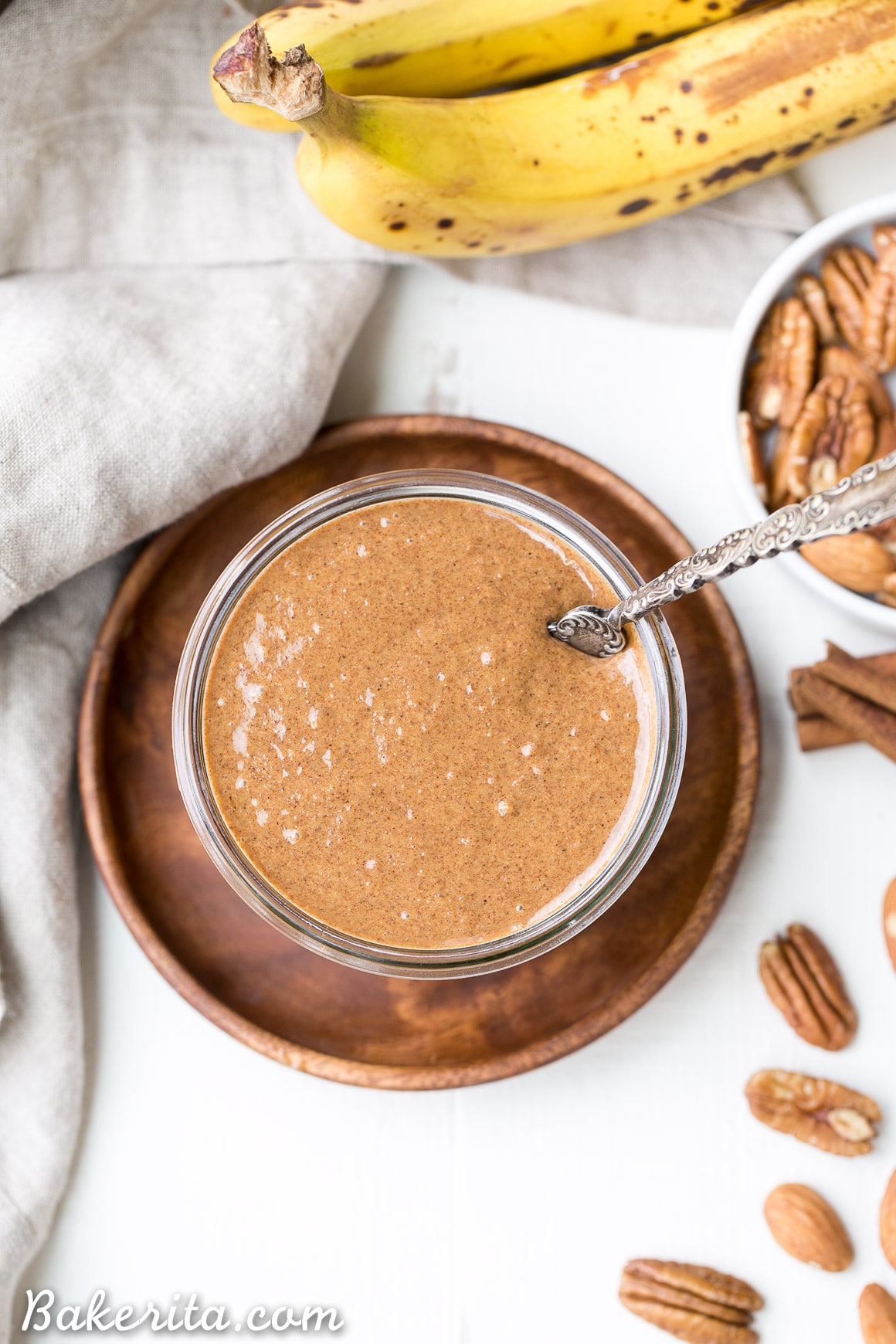 You'll want to spread this Banana Bread Pecan Almond Butter on everything! This creamy nut butter, made from pecans and almonds, tastes like a spreadable version of banana bread, loaded with cinnamon, nutmeg, and dried banana bits. There's no sugar added in this vegan, Paleo, + Whole30-approved treat.