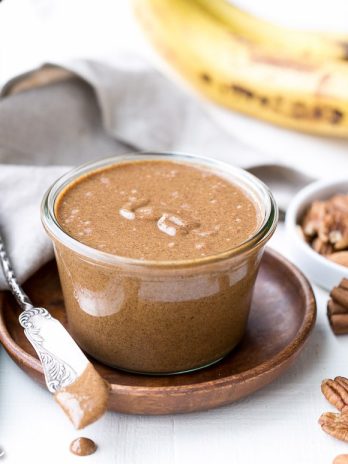 You'll want to spread this Banana Bread Pecan Almond Butter on everything! This creamy nut butter, made from pecans and almonds, tastes like a spreadable version of banana bread, loaded with cinnamon, nutmeg, and dried banana bits. There's no sugar added in this vegan, Paleo, + Whole30-approved treat.