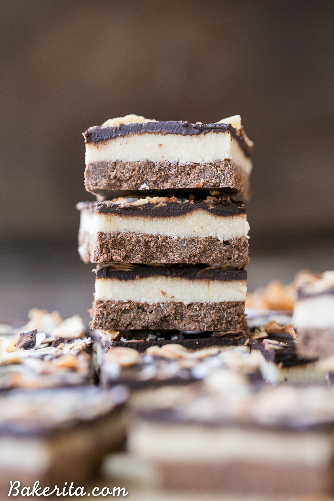 These Chocolate Coconut Bars have three irresistible layers - a chocolate shortbread crust, a melt-in-your-mouth coconut butter filling, and a chocolate topping with toasted coconut! Any coconut lover is going to love these gluten-free, Paleo + vegan dessert bars.
