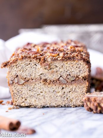 This Paleo Cinnamon Streusel Banana Bread has a layer of pecan crumble in the center and on top, creating a ripple of cinnamon flavor throughout the whole loaf of banana bread. This moist gluten-free + refined sugar free bread is sweetened with bananas and made with coconut flour.