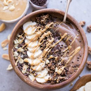 This Chocolate Peanut Butter Banana Smoothie Bowl tastes like a peanut butter cup, but it's actually a filling, superfood-packed breakfast that comes together in just 5 minutes! This gluten-free + vegan smoothie bowl is the perfect way to start the day.