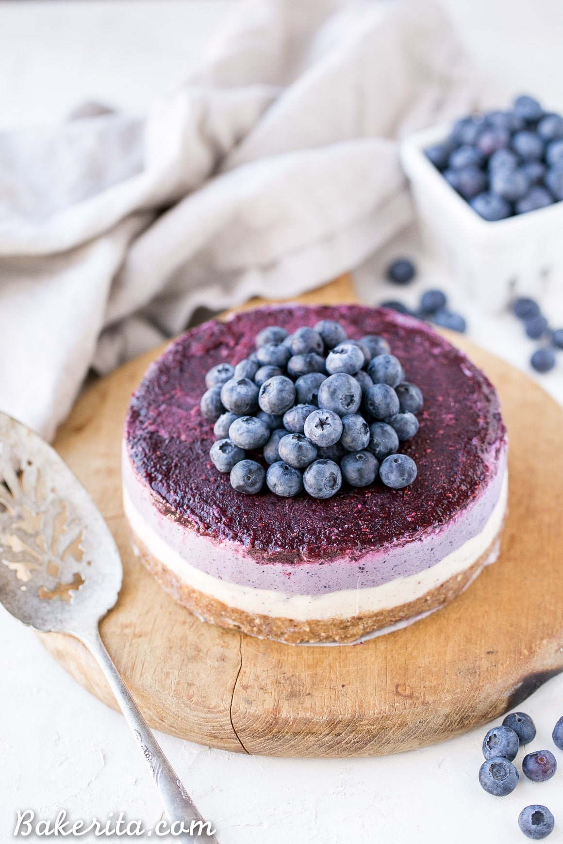 This No-Bake Layered Blueberry Cheesecake is a beautiful and easy-to-make Paleo-friendly + vegan cheesecake made with soaked cashews! The cheesecake layers are lusciously smooth and creamy with a tart, fruity topping.