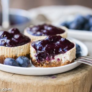 These Vanilla Bean Greek Yogurt Cheesecakes with Blueberry Compote are lightened up, but they're just as creamy and flavorful as traditional full-fat cheesecake. The easy blueberry compote takes this gluten free and refined sugar free dessert over the top!