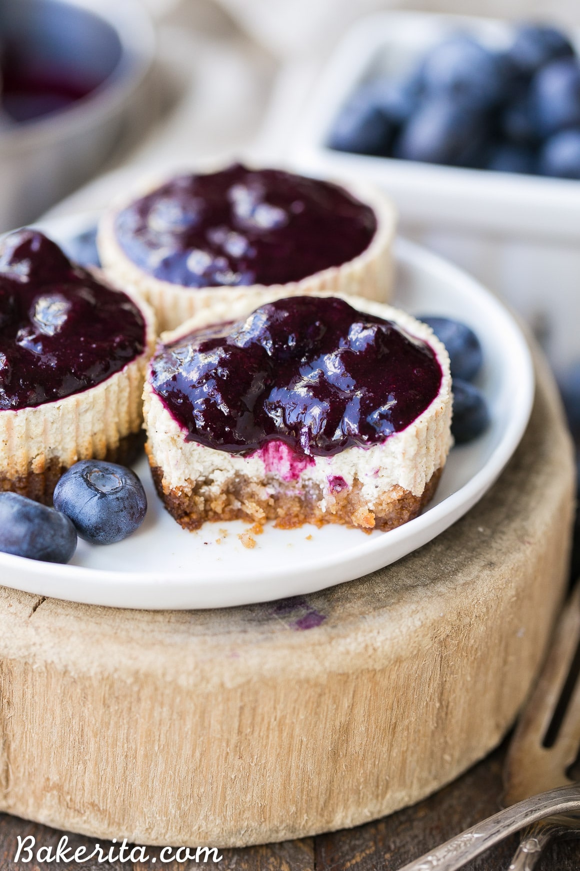 These Vanilla Bean Greek Yogurt Cheesecakes with Blueberry Compote are lightened up, but they're just as creamy and flavorful as traditional full-fat cheesecake. The easy blueberry compote takes this gluten free and refined sugar free dessert over the top!