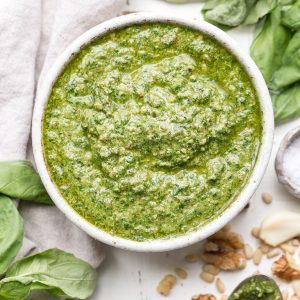 This Spinach Basil Pesto is loaded with bright herby flavor and made in just a few minutes. You won't miss the cheese in this paleo, vegan + Whole30-friendly pesto. It will make any meal more flavorful, whether it's tossed with pasta, enjoyed with your favorite protein, or used as a spread.