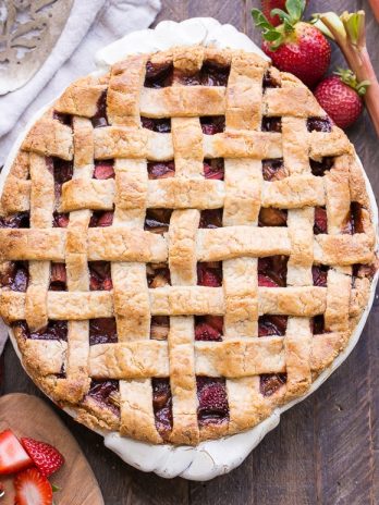 This Paleo Strawberry Rhubarb Pie is bursting with fresh strawberries and rhubarb, creating a delectable tart + sweet pie! The crisp and flaky gluten-free + grain-free crust is the perfect vessel for the lightly spiced fruit filling.