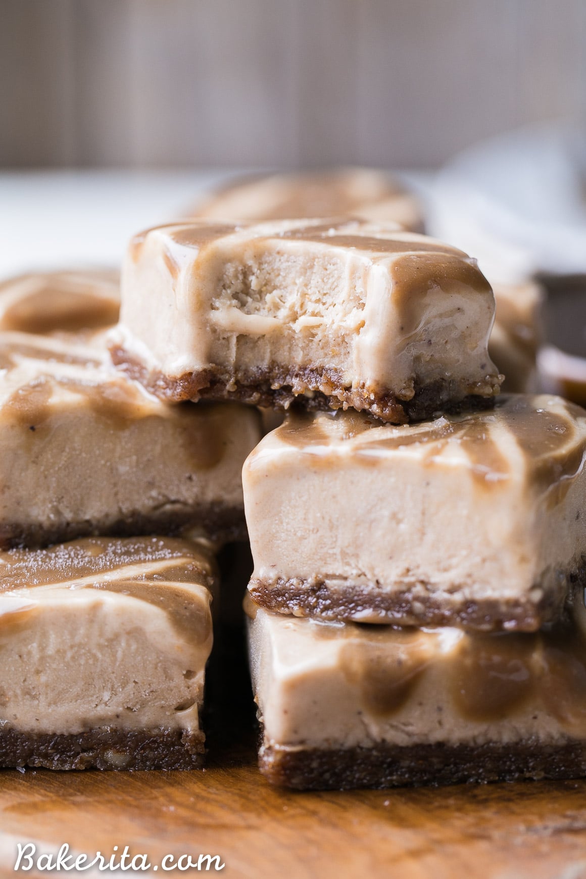 These Frozen Caramel Banana Bars are easy to make in a blender or food processor, and they're super creamy and refreshing. These gluten-free and paleo bars have a chewy pecan-date crust, topped with banana nice cream and a caramel swirl.