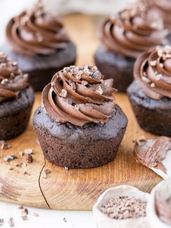These Paleo Chocolate Zucchini Cupcakes are topped with a rich and fudgy Paleo Chocolate Frosting! You'd never guess there are veggies packed into these super moist and chocolatey cupcakes.