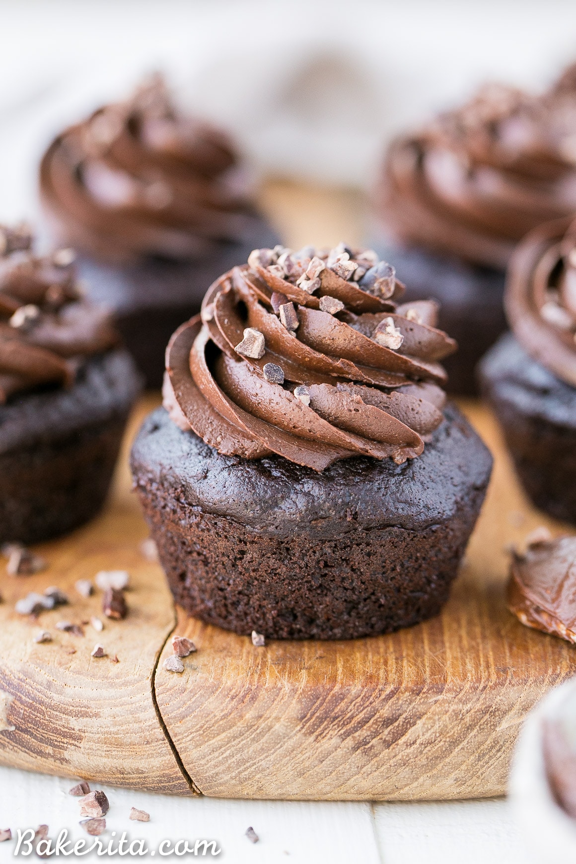 These Paleo Chocolate Zucchini Cupcakes are topped with a rich and fudgy Paleo Chocolate Frosting! You'd never guess there are veggies packed into these super moist and chocolatey gluten-free cupcakes.