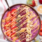 This Peanut Butter & Jelly Smoothie Bowl is smooth, creamy, and delicious - the flavors will bring you right back to your favorite childhood sandwich. This gluten-free and vegan breakfast bowl has a secret vegetable ingredient packed in too - shhh!