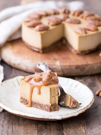 This No Bake Pumpkin Cheesecake is super creamy with a pecan crust and a spiced pumpkin cheesecake filling that's made with cashews! This healthier pumpkin cheesecake is gluten-free, dairy-free, paleo + vegan, and absolutely perfect for the holidays.