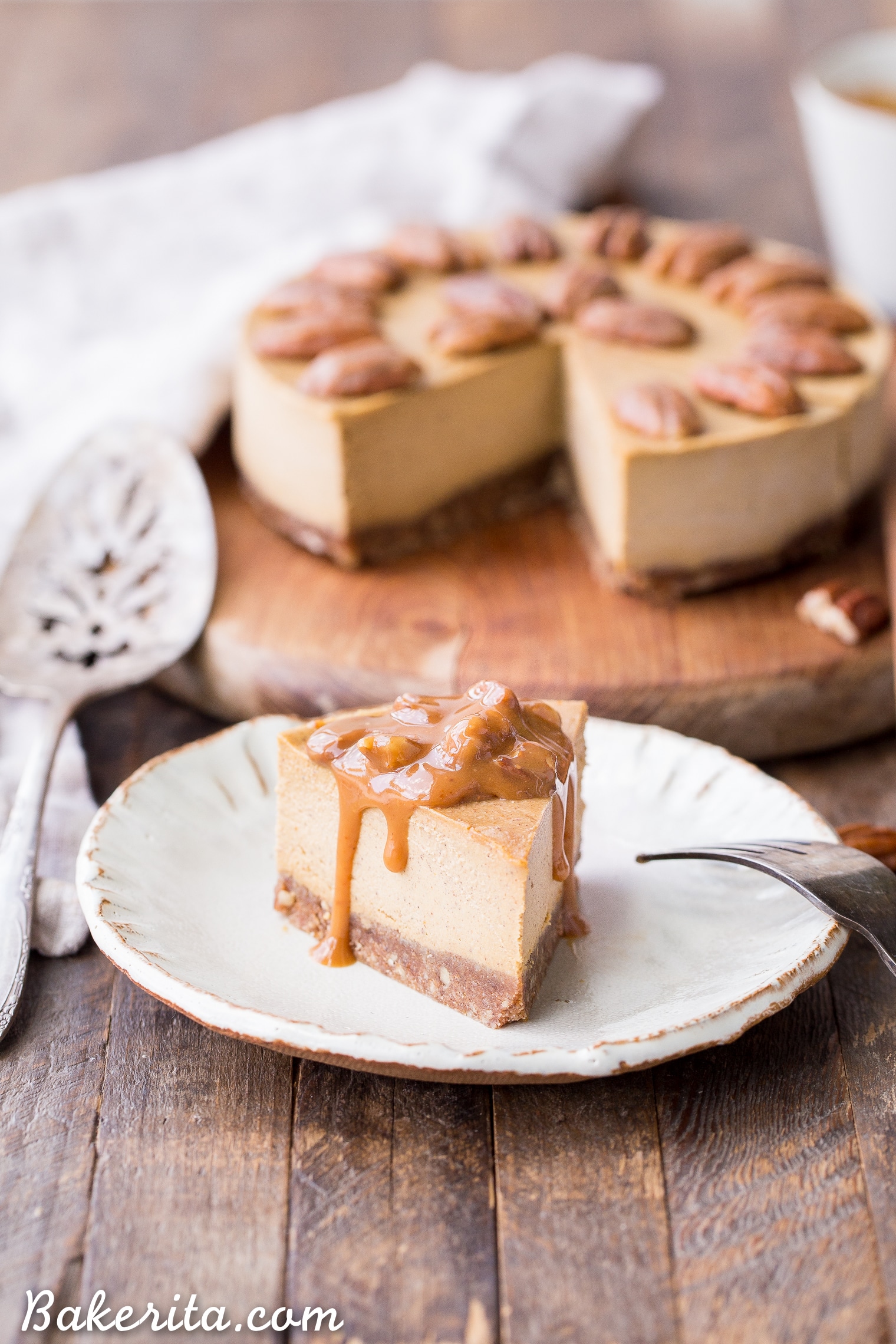 This No Bake Pumpkin Cheesecake is super creamy with a pecan crust and a spiced pumpkin cheesecake filling that's made with cashews! This healthier pumpkin cheesecake is gluten-free, dairy-free, paleo + vegan, and absolutely perfect for the holidays.