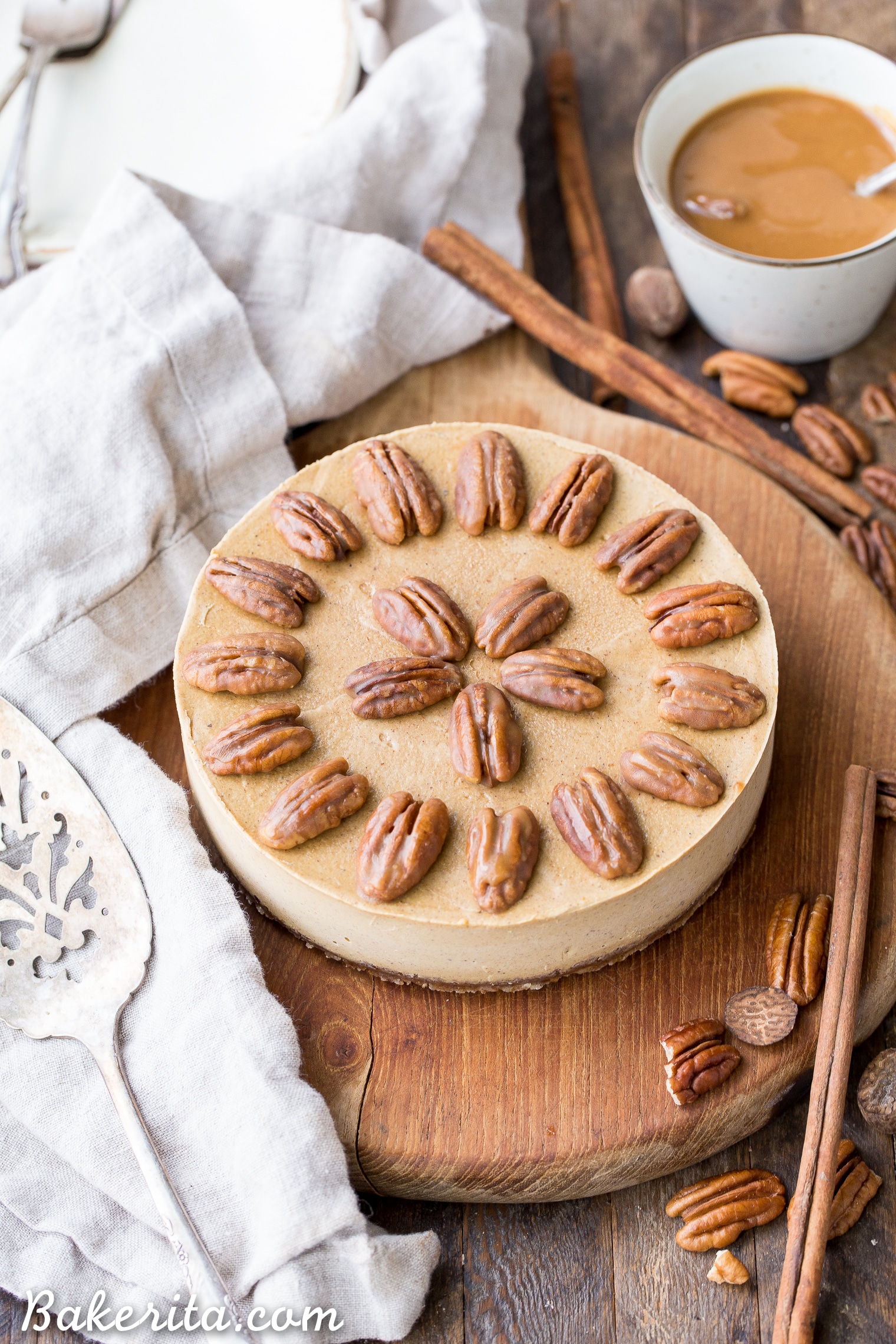 This No Bake Pumpkin Cheesecake is super creamy with a pecan crust and a spiced pumpkin cheesecake filling that's made with cashews! This healthier pumpkin cheesecake is gluten-free, dairy-free, paleo + vegan, and absolutely perfect for the holidays.