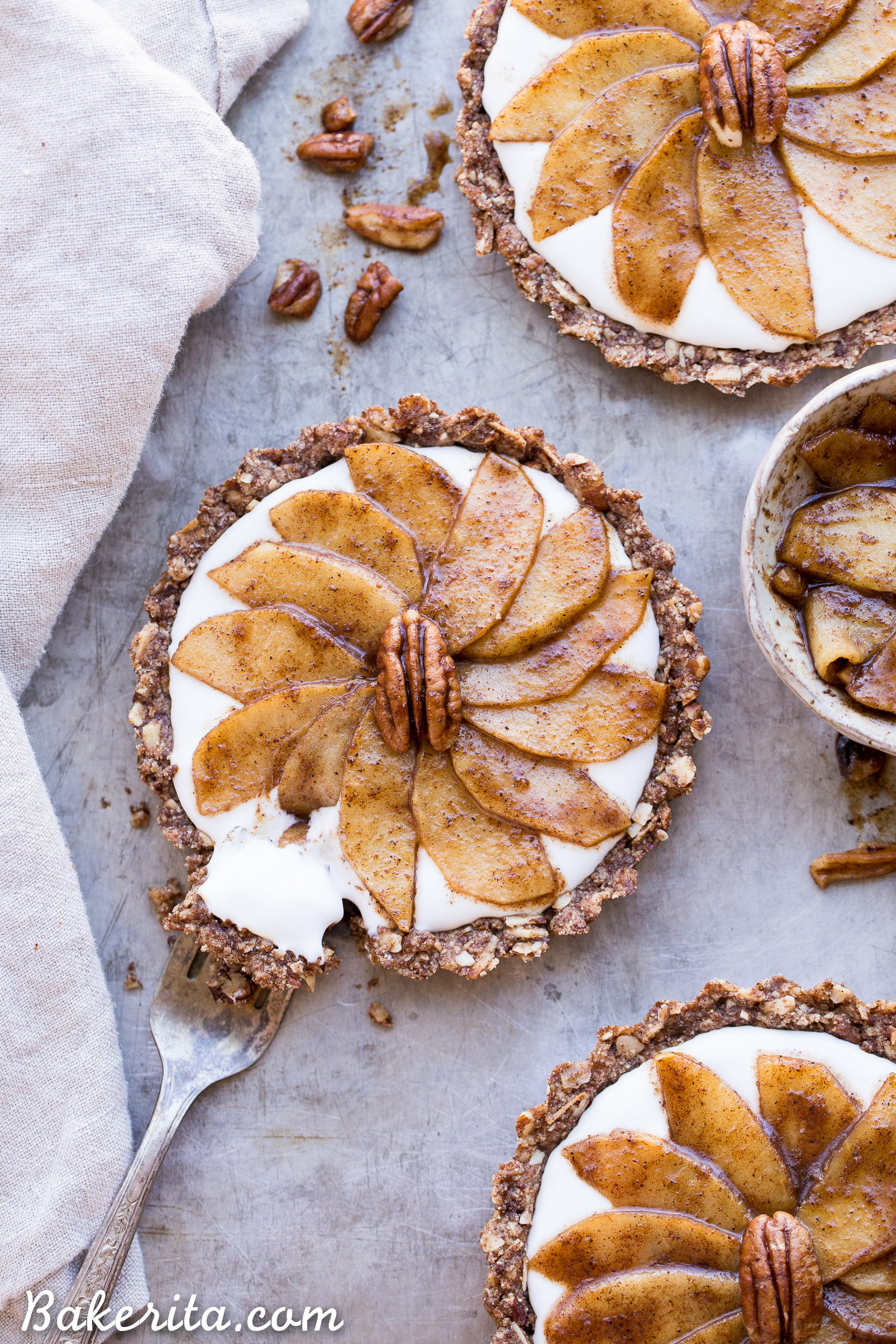 These Granola Breakfast Tarts with Sauteed Apples + Coconut Yogurt are an incredible breakfast treat that's so good, you'll think it's dessert! The granola crust is spread with creamy dairy-free coconut yogurt and topped with cinnamon sauteed apples. This gluten-free, paleo and vegan breakfast is the perfect holiday morning breakfast, or to make any morning more special.